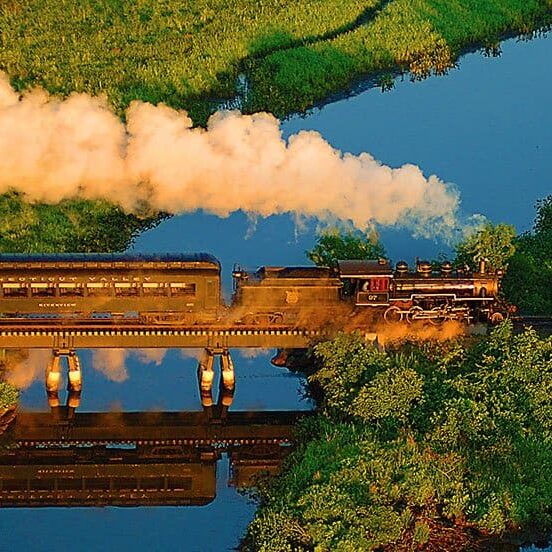 Essex vintage steam train billowing smoke in the scenic Connecticut River Valley.